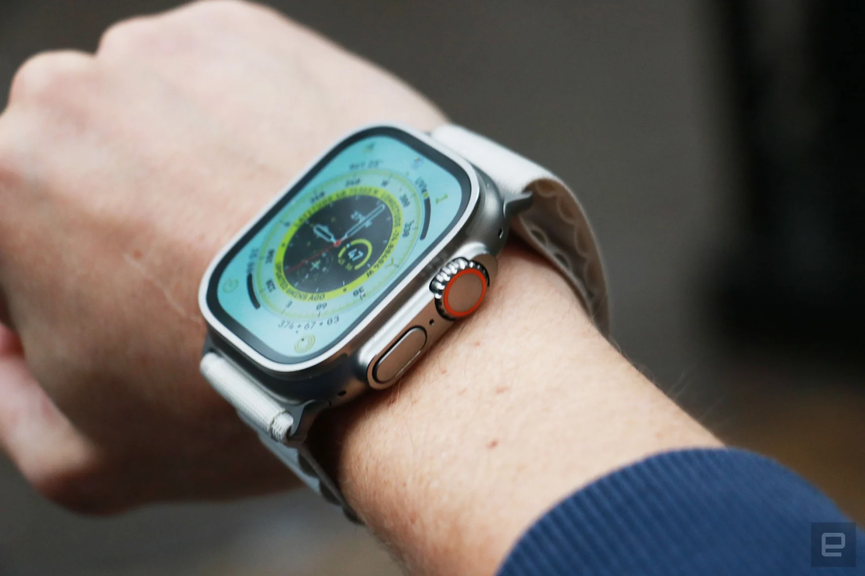 Off-angle view of the Apple Watch Ultra on a person's wrist, with the Wayfinder watch face on its screen.