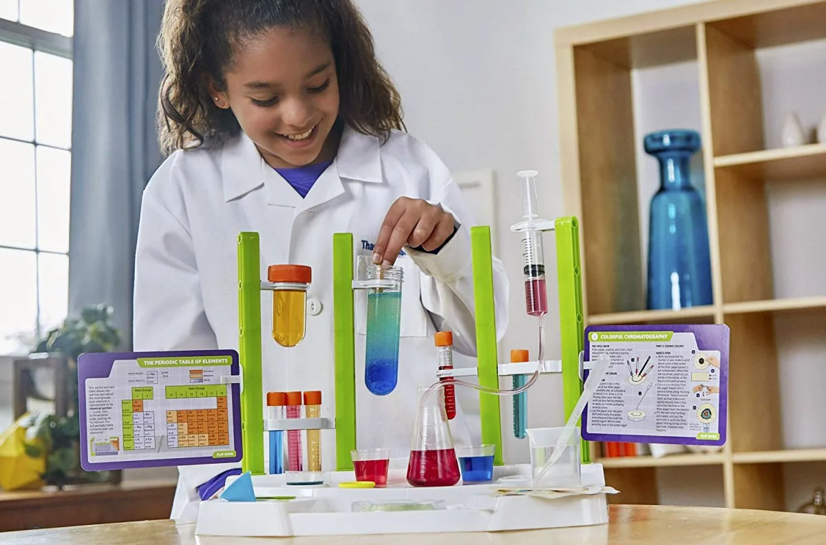 Thames & Kosmos Ooze Labs Chemistry Station Science Experiment Kit with girl playing