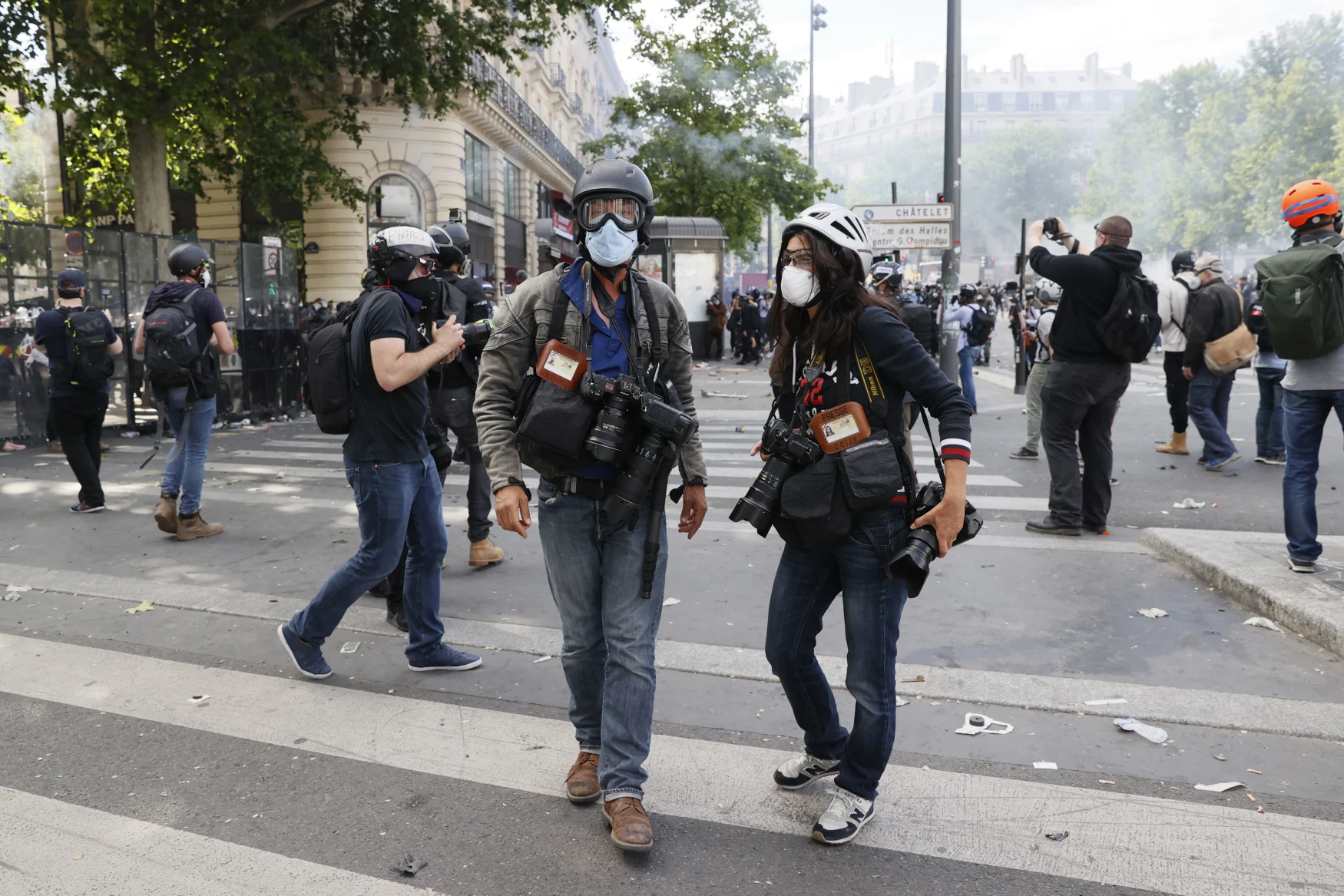A photo shows AFP photographer Anne-Christine Poujoulat (R) and photographer Jean-Baptiste Autissier during a rally as part of the 'Black Lives Matter' worldwide protests against racism and police brutality, on Place de la Republique in Paris on June 13, 2020. - A wave of global protests in the wake of US George Floyd's fatal arrest magnified attention on the 2016 death in French police custody of Adama Traore, a 24-year-old black man, and renewed controversy over claims of racism and brutality within the force. (Photo by Thomas SAMSON / AFP) (Photo by THOMAS SAMSON/AFP via Getty Images)