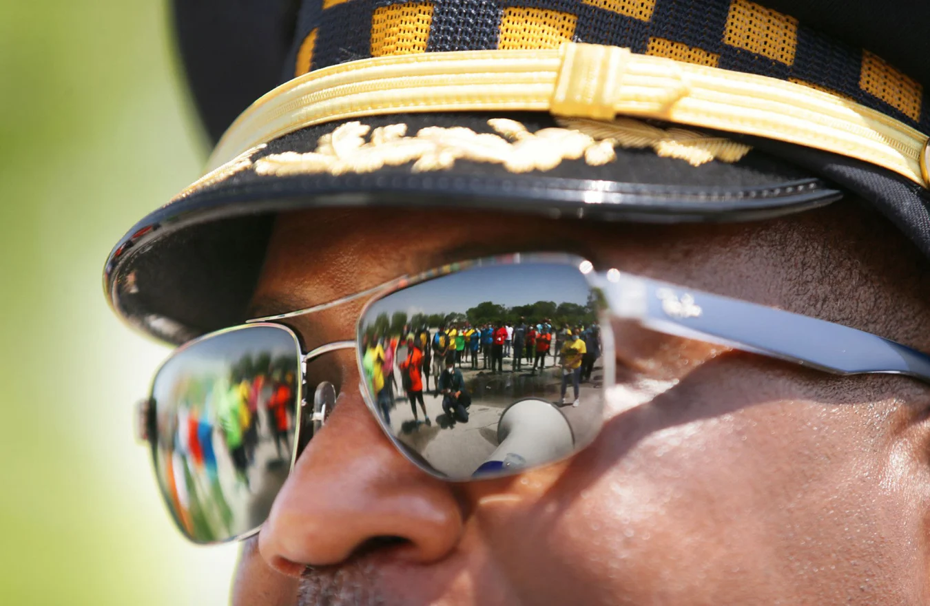 Marchers are reflected in the sunglasses of a Chicago police official during a rally in the city's Roseland neighborhood on June 10, 2020. (Stacey Wescott/Chicago Tribune/Tribune News Service via Getty Images)