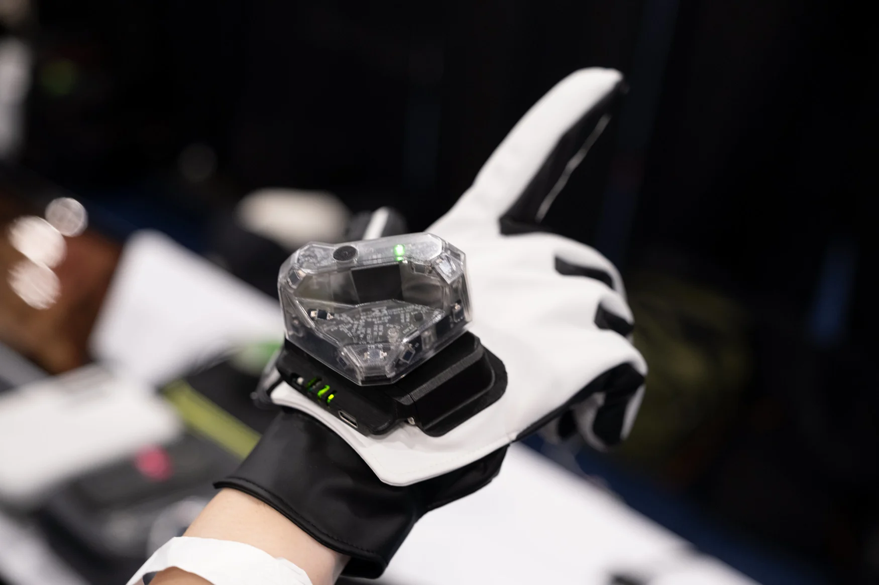 A VR glove is shown with a haptic sensor on top.
