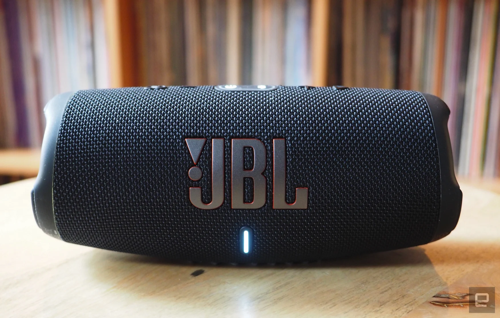 The JBL Charge 5 photographed for Engadget's 2022 portable Bluetooth speaker guide in front of a shelf full of records.
