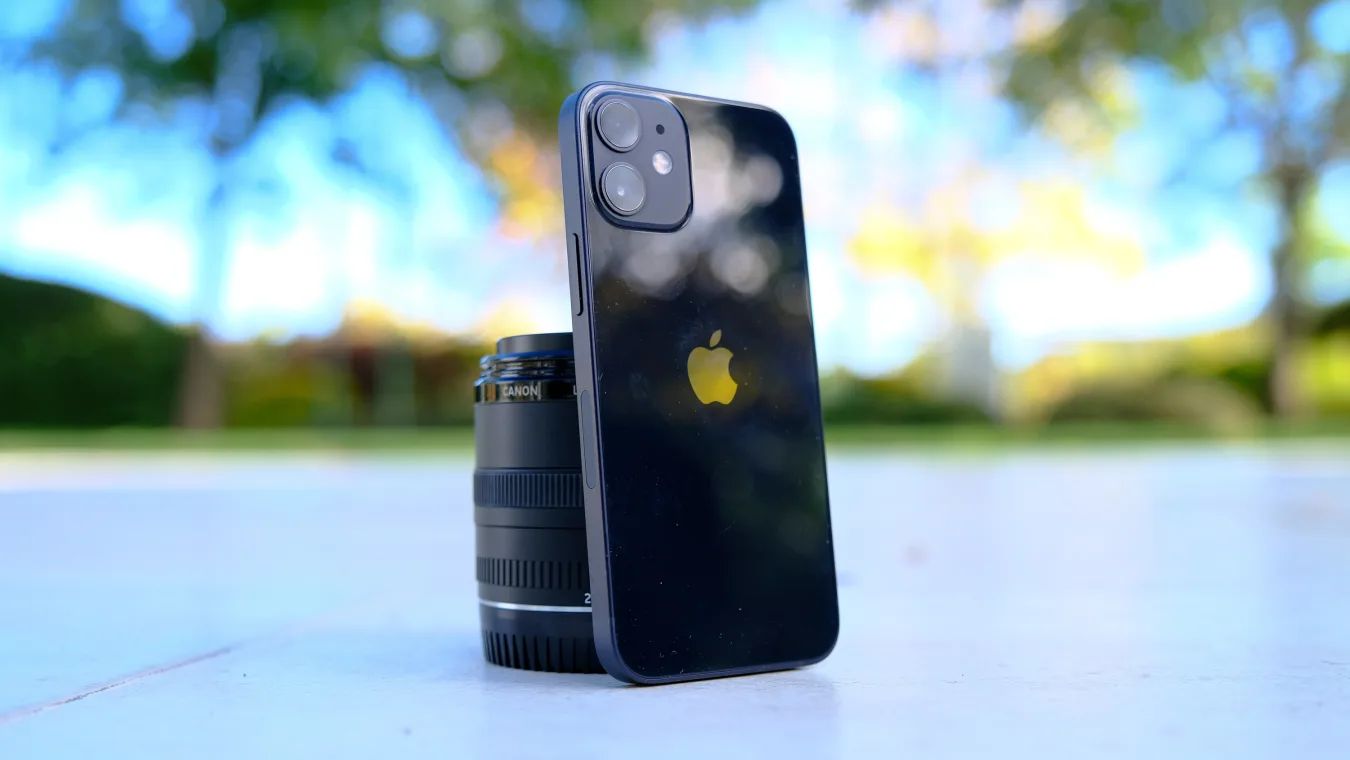 Apple iPhone 12 mini against a camera lens