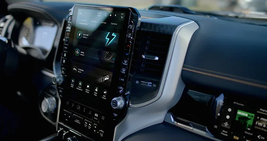 An interior shot of the RAM 1500 Rev, showing off the truck's large infotainment unit. 