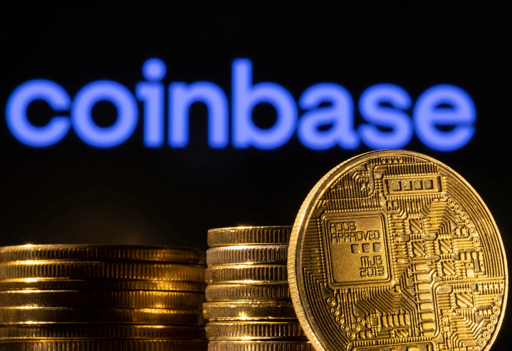 A representation of the cryptocurrency is seen in front of Coinbase logo in this illustration taken, March 4, 2022. REUTERS/Dado Ruvic/Illustration