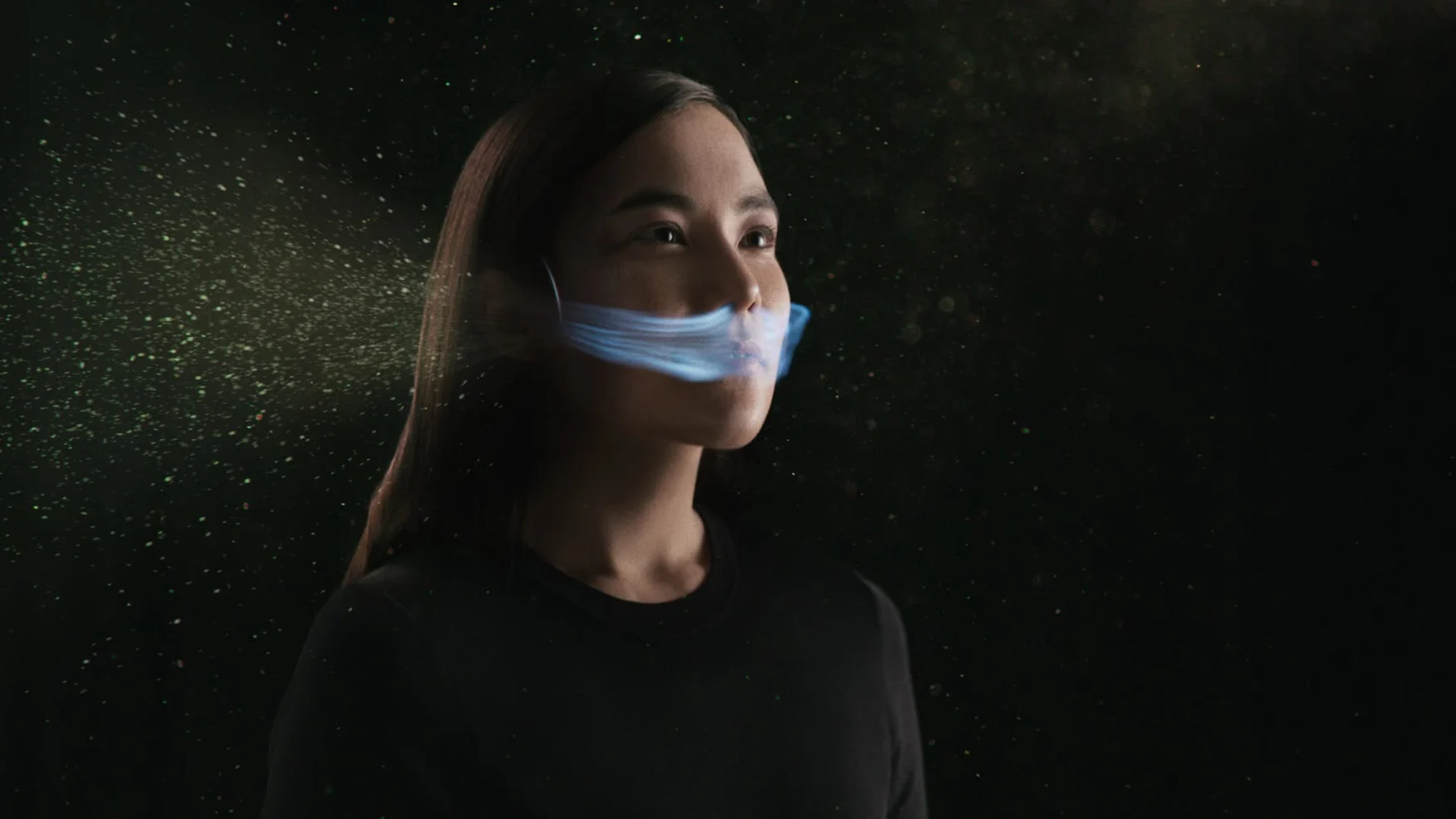 A picture with visualizations depicting how dust particles and air would flow around a person wearing the Dyson Zone.