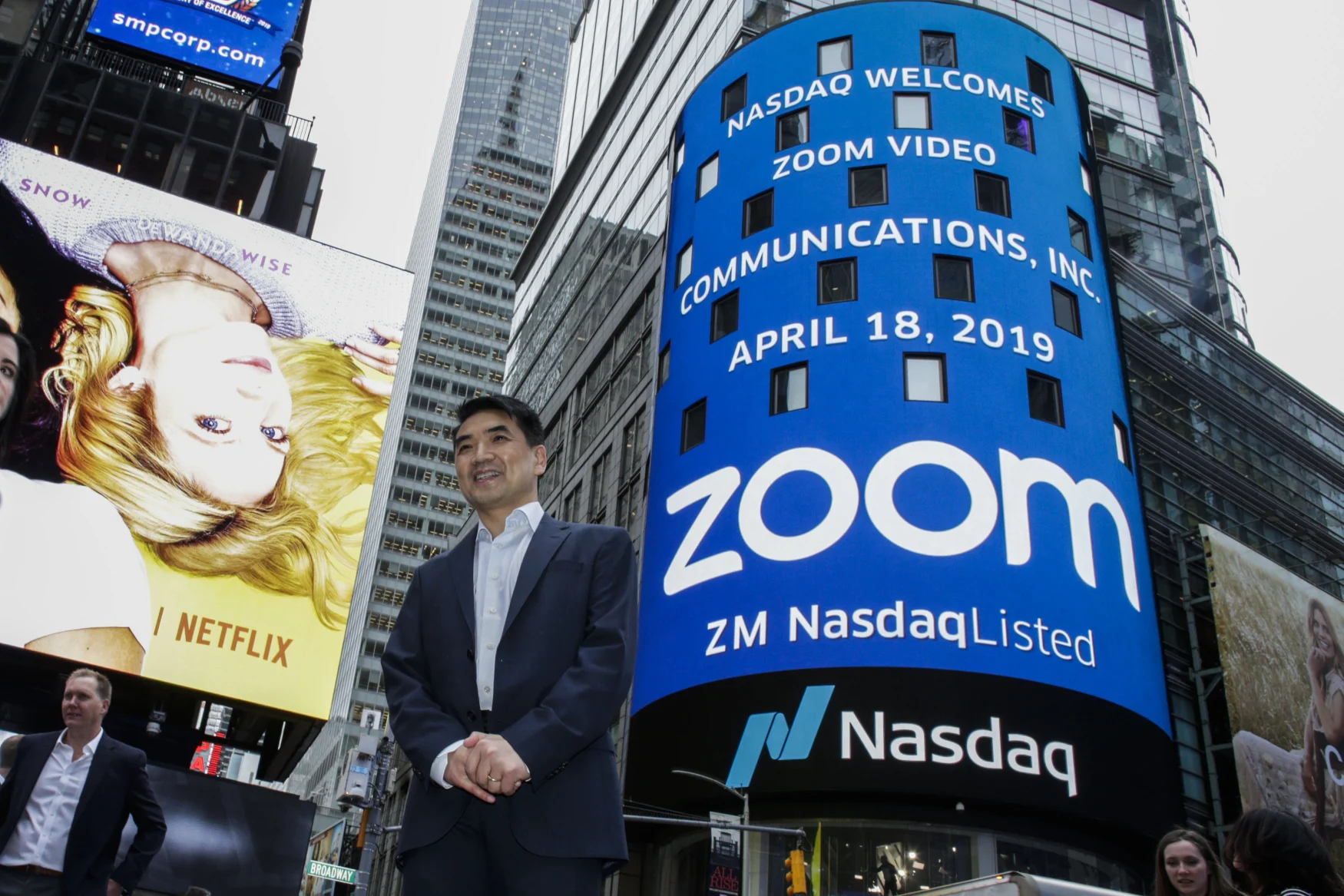 NEW YORK, NY - APRIL 18: Zoom founder Eric Yuan poses in front of the Nasdaq building as the screen shows the logo of the video-conferencing software company Zoom after the opening bell ceremony on April 18, 2019 in New York City. The video-conferencing software company announced it's IPO priced at $36 per share, at an estimated value of $9.2 billion. (Photo by Kena Betancur/Getty Images)