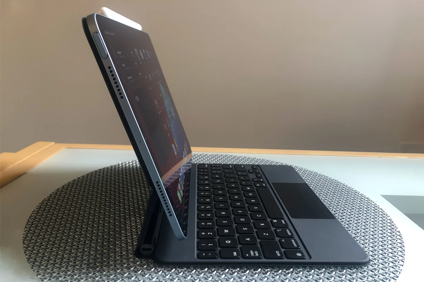 A side view of the 2020 Apple iPad Air, with the Magic Keyboard accessory attached.