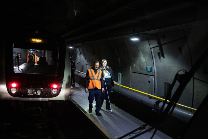 Image of a passenger being walked to safety along the Crossrail emergency escape route during trial running.