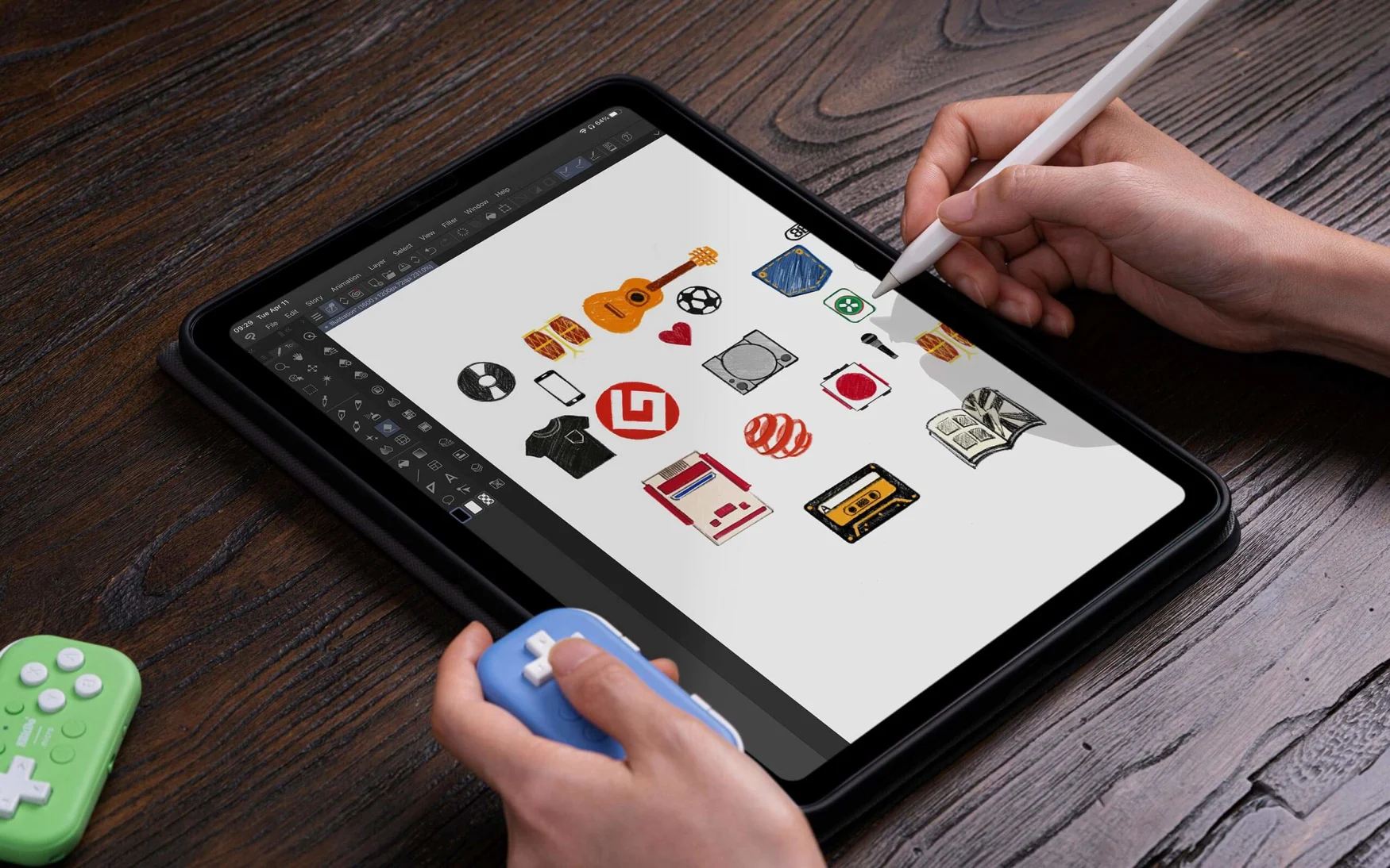 Marketing photo of a person holding an 8BitDo Micro (tiny blue) controller in their left hand and an Apple Pencil in their right hand as they sketch in an illustration app on an iPad. It sits on a dark wooden table with a green 8BitDo Micro gamepad sitting to the left.
