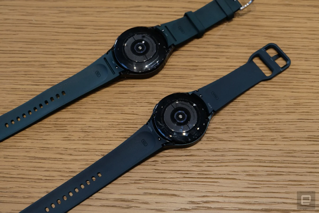 The underside of two black Galaxy Watch 4s.