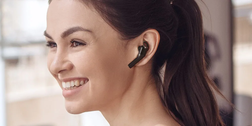 Press image of the TREBLAB X5 True Wireless Bluetooth Earbuds, as worn by a female model.
