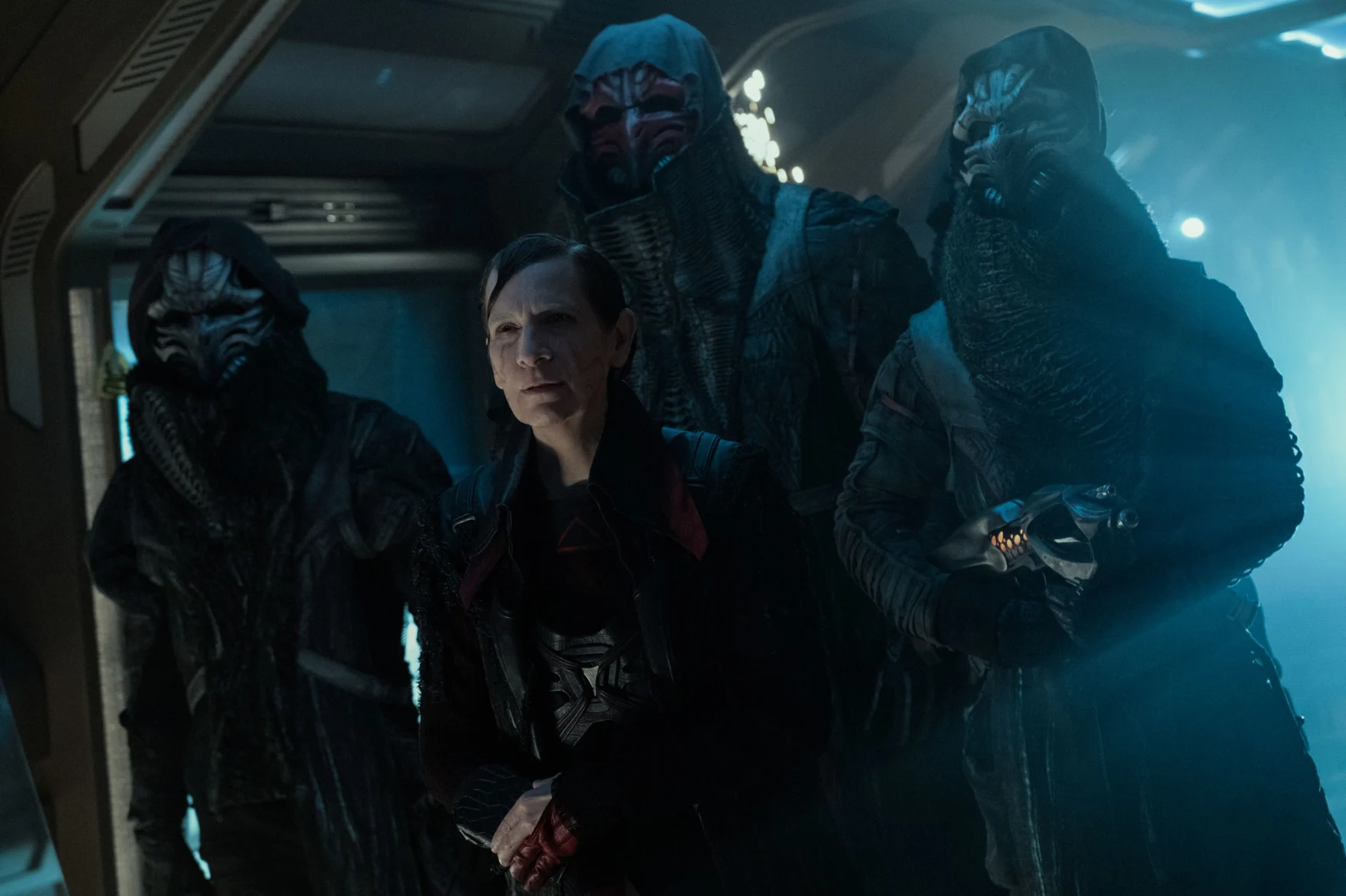 Image of Amanda Plummer and some aliens in a dark corridor in an unnamed location during 'Star Trek: Picard's third season