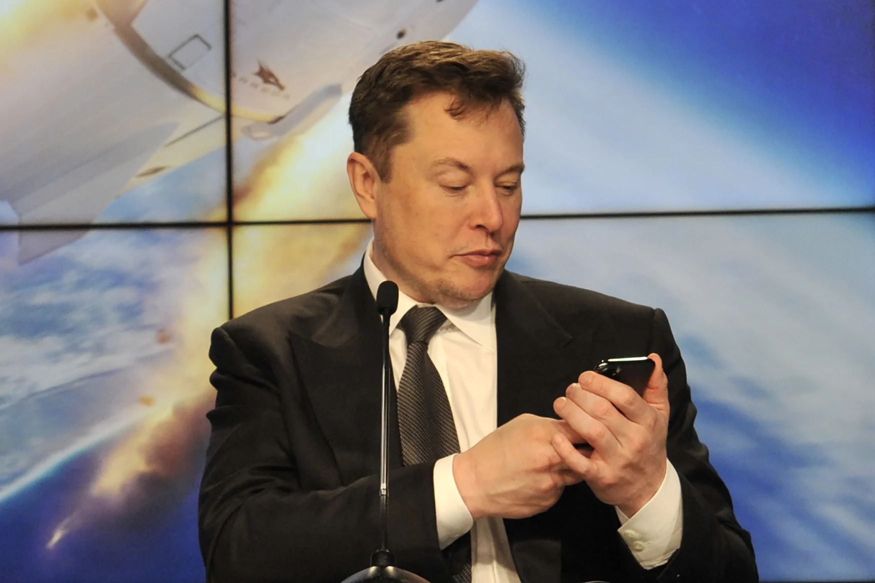 SpaceX founder and chief engineer Elon Musk looks at his mobile phone during a post-launch news conference to discuss the  SpaceX Crew Dragon astronaut capsule in-flight abort test at the Kennedy Space Center in Cape Canaveral, Florida, U.S. January 19, 2020. REUTERS/Steve Nesius