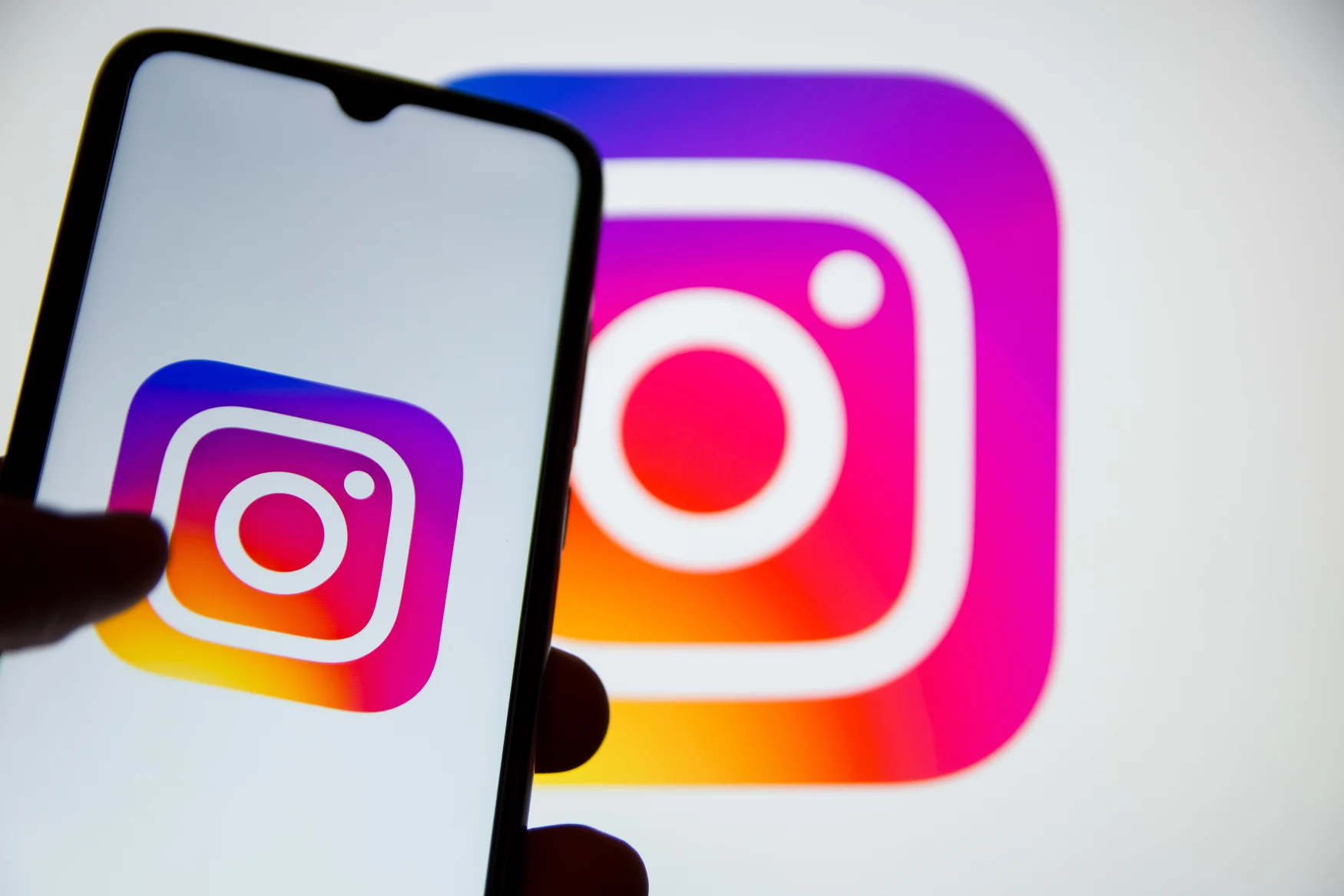 In this photo illustration Instagram logo seen displayed on a smartphone screen with Instagram logo in the background in Athens, Greece on October 31, 2022. Instagram accounts are being closed. Users will neither be able to send messages nor will they be able to post. (Photo illustration by Nikolas Kokovlis/NurPhoto via Getty Images)