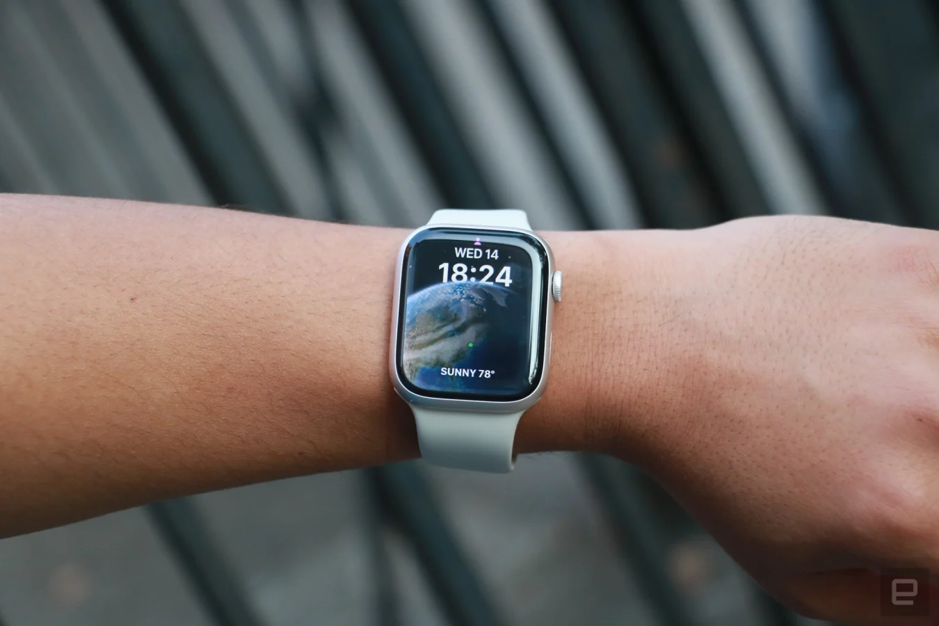 The Apple Watch Series 8 on a wrist held up in mid-air.
