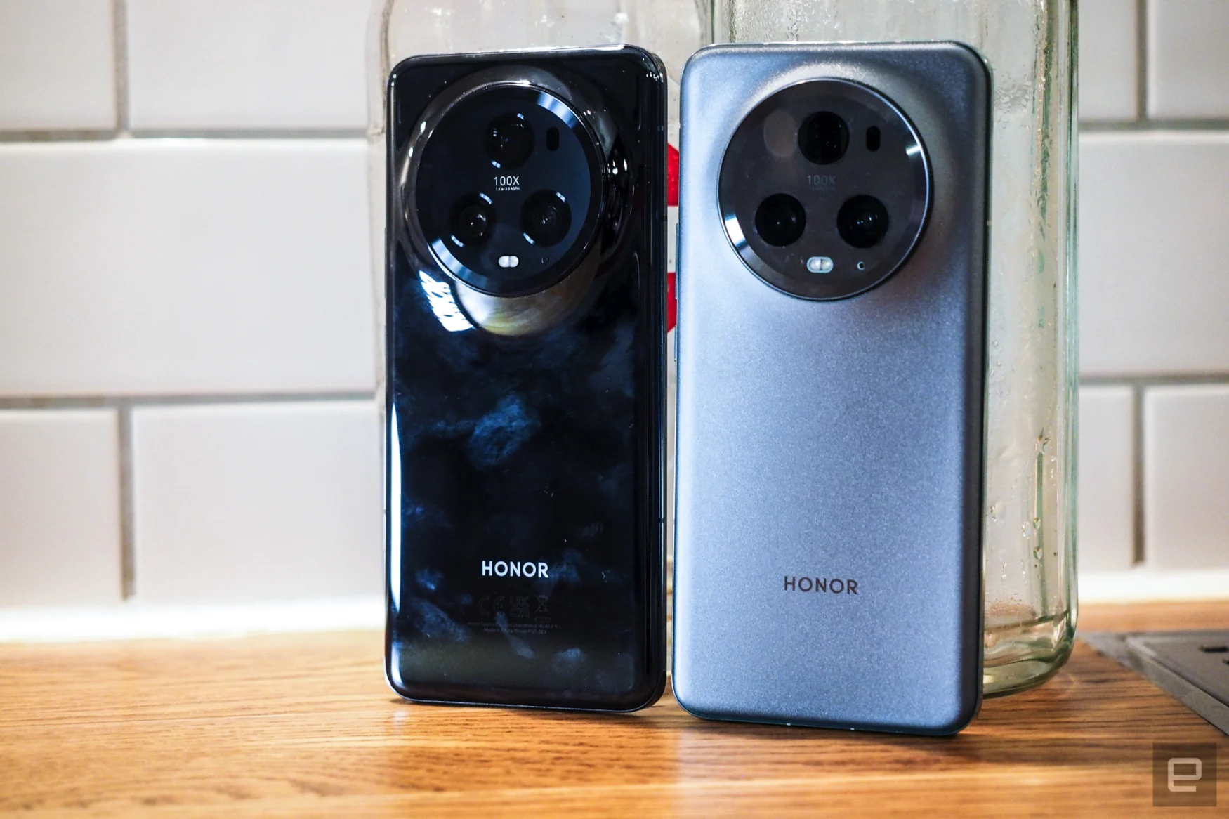 Image of both colorways of Honor's Magic 5 Pro side-by side, including the fingerprint-smeared piano gloss black (which I'd wiped seconds before) and the green version, which looks more petrol in the images.