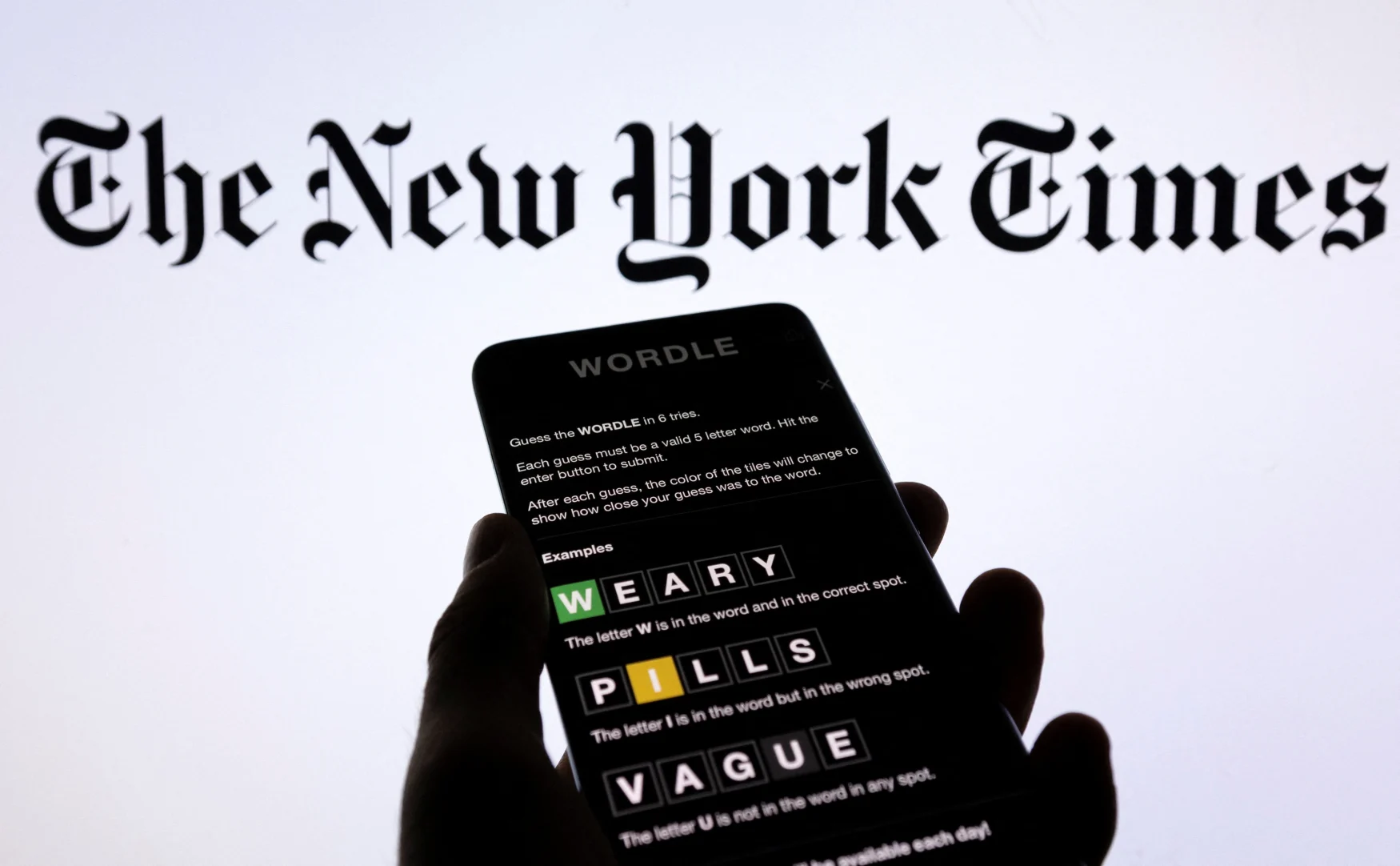 Wordle app game is seen on a smartphone in front of The New York Times logo in this picture illustration, February 1, 2022. Picutre taken February 1, 2022 REUTERS/Dado Ruvic/Illustration