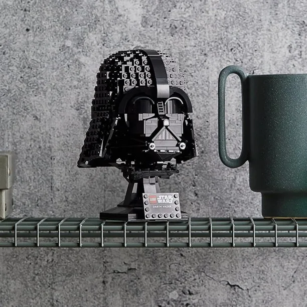 Darth Vader's face made out of LEGOs sitting on a wire shelf.