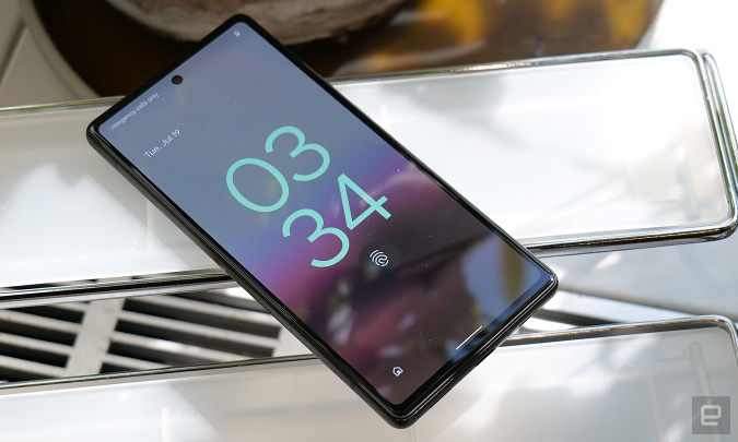 The Pixel 6a shows its lock screen with a fingerprint icon below the clock widget.