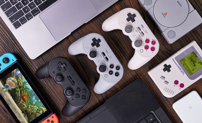 An overview photo of the 8BitDo Pro 2 gaming controller lined up neatly next to a variety of compatible game platforms.