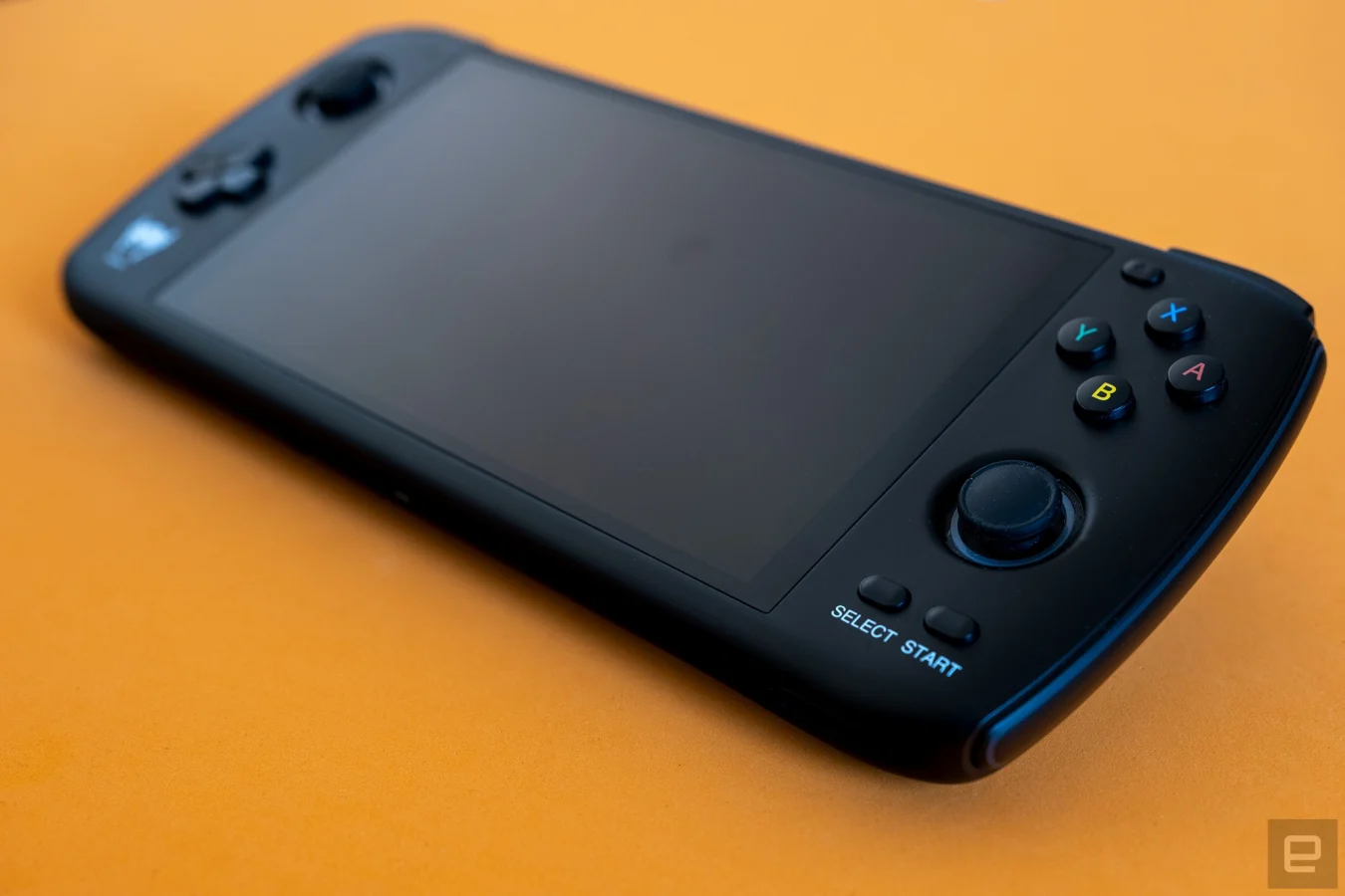 The new retro handheld from Ayn, called the Odin, is pictured with a close up of the main buttons and analog stick.