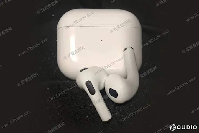 Two white wireless earbuds on top of a white charging case. Image is covered with a translucent watermark with Chinese characters and the url 