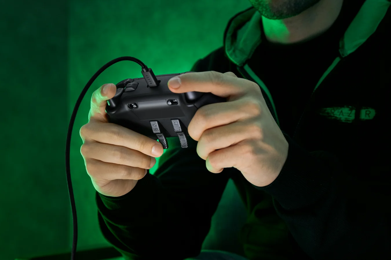 Razer Wolverine V2 Chroma from rear, held in a man's hands, back triggers visible