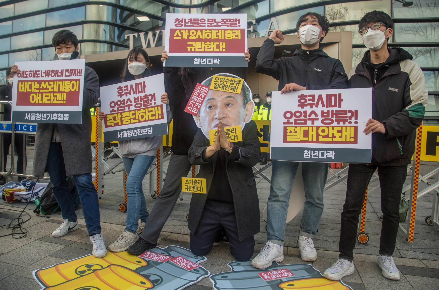 SEOUL, SOUTH KOREA - 2021/04/13: An activist wearing a cut out depicting Japanese Prime Minister Yoshihide Suga, while colleagues holding placards expressing their opinion during the demonstration.
South Korean activists protest against the Japanese government's decision to discharge radioactive water from Fukushima Daiichi Nuclear Power Plant in Japan, in front of the Japanese Embassy in Seoul. (Photo by Jaewon Lee/SOPA Images/LightRocket via Getty Images)