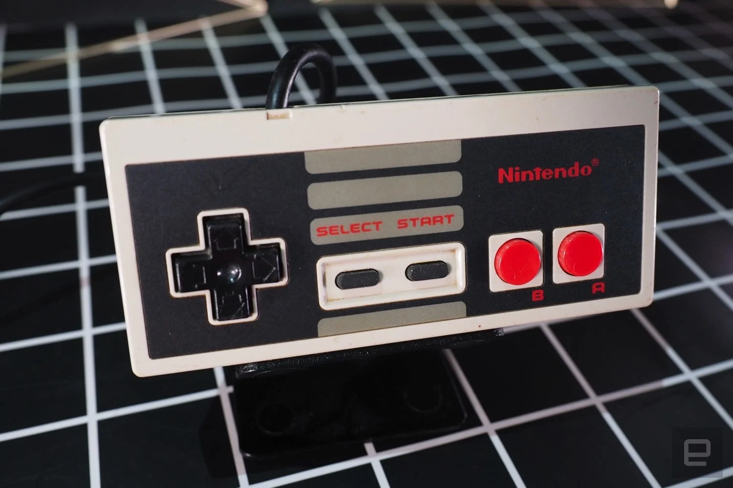 A close up of a Nintendo Entertainment System controller.