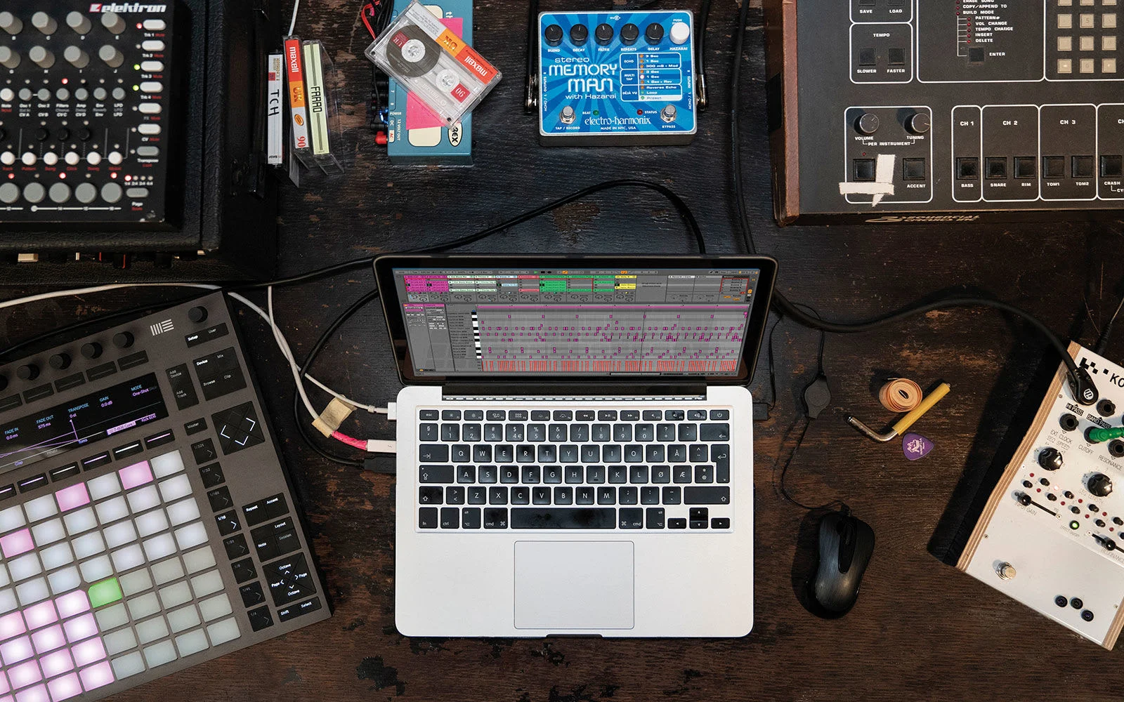 An overhead view of Ableton Live 10 on a laptop surrounded by home studio gear.