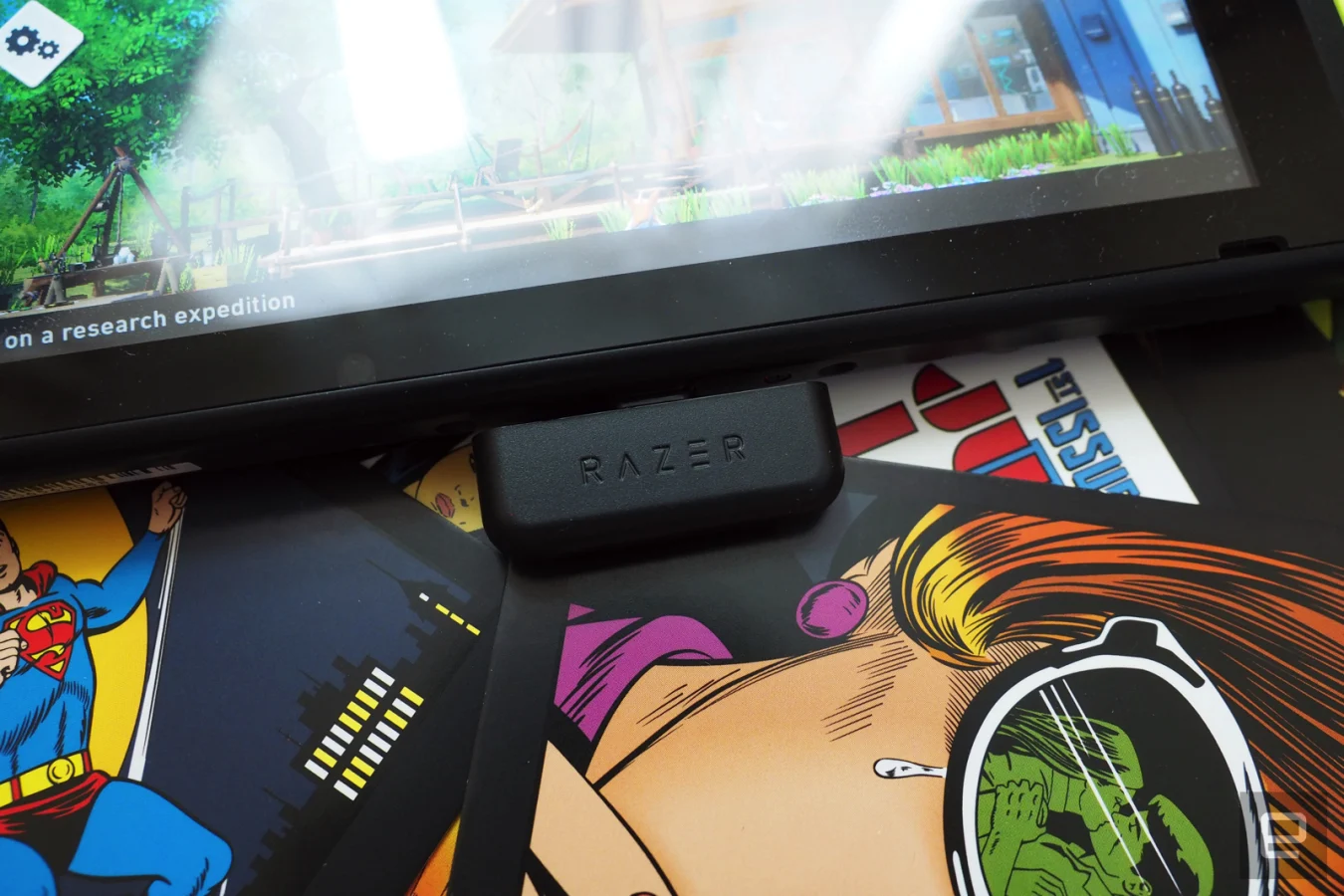 Razer Barracuda X in black on a field of comic images