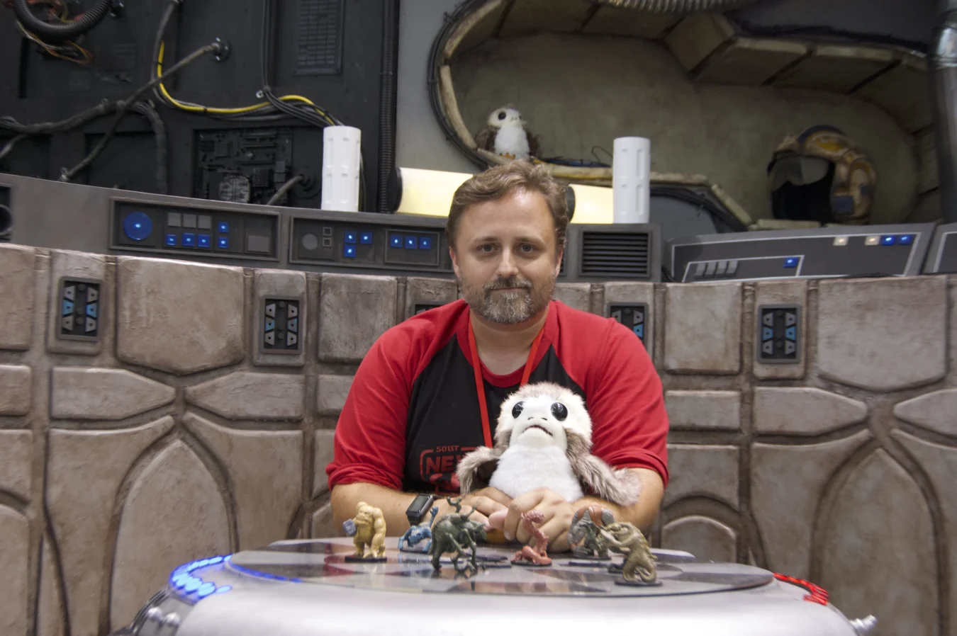 Brian Anderson sits in the Millennium Falcon’s lounge booth at FAN EXPO Boston in 2019. He’s spent decades building costumes of all types, and has focused extensively on 3D printing, making everything from droids to costumes to the game figures sitting on the table before him.