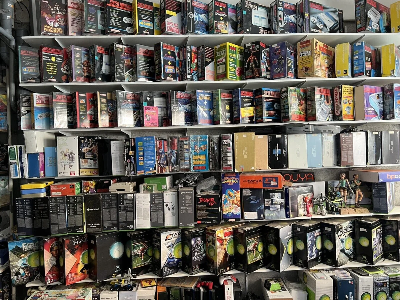 A collection of video game consoles including Nintendo and Xbox products.