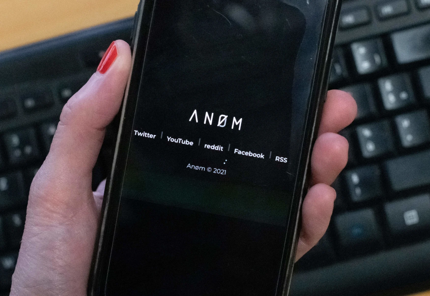An illustration picture shows the ANoM logo displayed on the screen of an smartphone on june 8, 2021 in Paris. - Some 250 people were arrested in Sweden and Finland in the global sting on organised crime, authorities said on June 8, 2021, using phones planted by the US FBI, law enforcement officers were able to read the messages of global underworld figures in around 100 countries as they plotted drug deals, arms transfers and gangland hits on the compromised ANOM devices. (Photo by Olivier MORIN / AFP) (Photo by OLIVIER MORIN/AFP via Getty Images)
