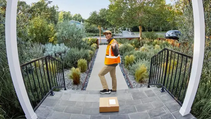 Image of a package delivery person dropping a package in full view.