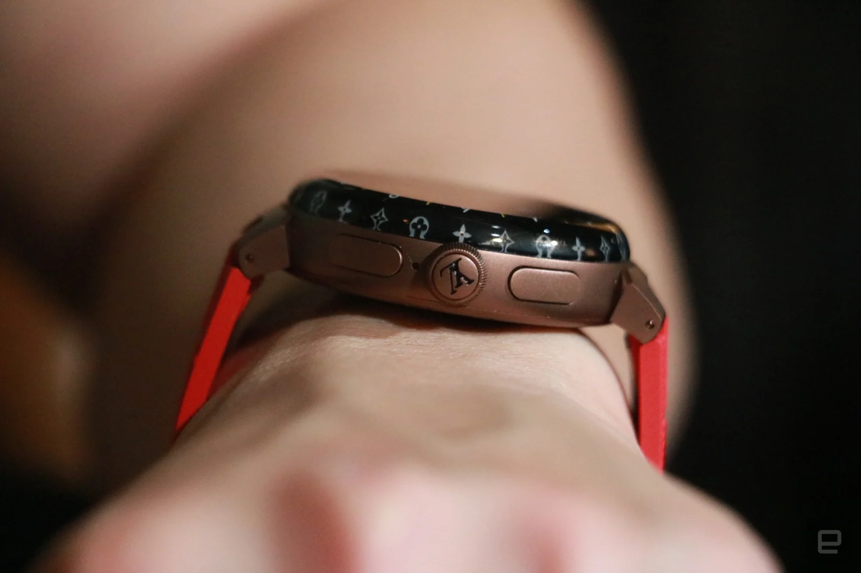 Side view of the Louis Vuitton Tambour Horizon Light Up smartwatch, showing the company's logo on its dial and two other buttons on the edge.