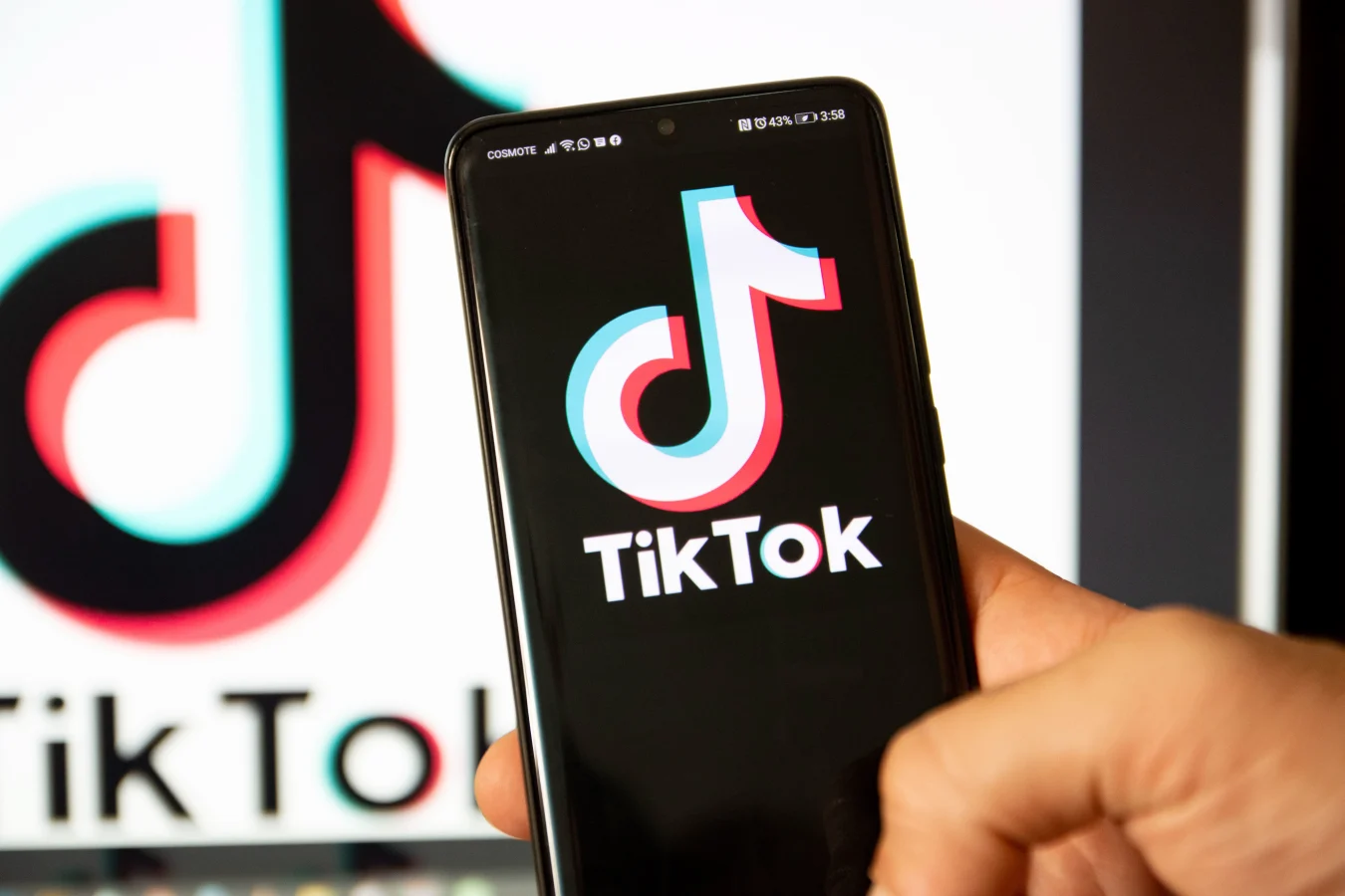 TikTok closeup logo displayed on a phone screen, smartphone and keyboard are seen in this multiple exposure illustration. Tik Tok is a Chinese video-sharing social networking service owned by a Beijing based internet technology company, ByteDance.  It is used to create short dance, lip-sync, comedy and talent videos. ByteDance launched TikTok app for iOS and Android in 2017 and earlier in September 2016 Douyin fror the market in China. TikTok became the most downloaded app in the US in October 2018. President of the USA Donald Trump is threatening and planning to ban the popular video sharing app TikTok from the US because of the security risk. Thessaloniki, Greece - August 1, 2020 (Photo by Nicolas Economou/NurPhoto via Getty Images)