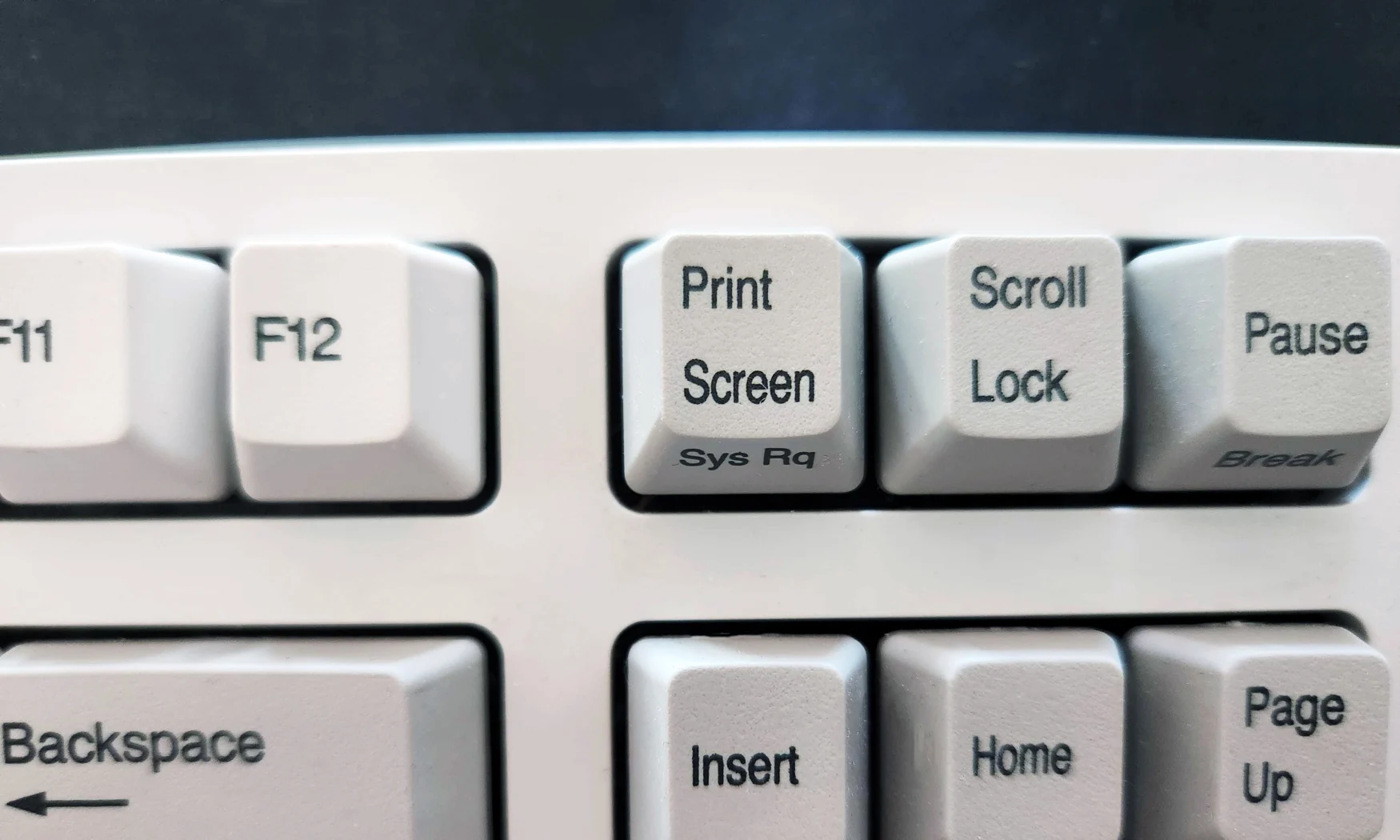 A photo of the Print Screen button on a keyboard.