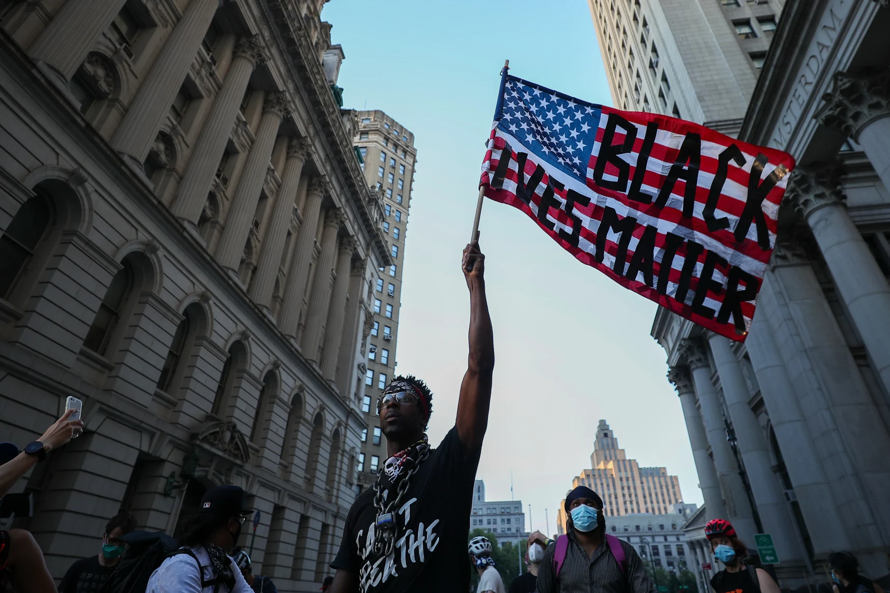 NEW YORK, USA - JUNE 23: A man waves a U.S flag reading 'Black Lives Matter' during an anti-racism protest in New York City, United States on June 23, 2020. The protestors have occupied the City Hall Park in New York City after marching around the City Hall and One Police Plaza. (Photo by Tayfun Coskun/Anadolu Agency via Getty Images)