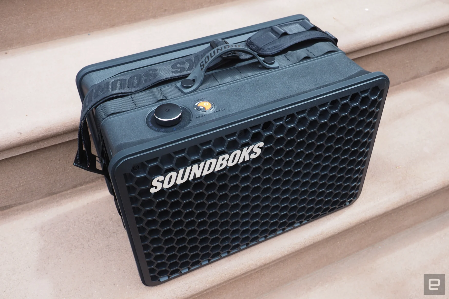 The Soundboks Go portable Bluetooth speaker seen on the front steps of a Brooklyn brownstone.