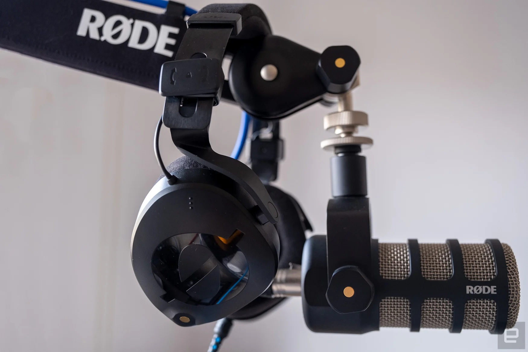 Rode's NTH-100 headphones are pictured alongside a Rode podcasting microphone.