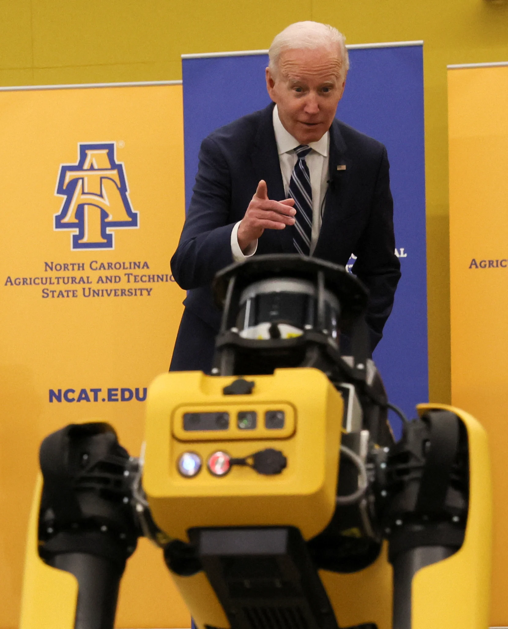 U.S. President Joe Biden gestures at a robot dog called 'Spot' at the Robotics Lab, North Carolina Agricultural and Technical State University, Harold L. Martin Engineering Research and Innovation Complex in Greensboro, North Carolina, U.S., April 14, 2022. REUTERS/Leah Millis
