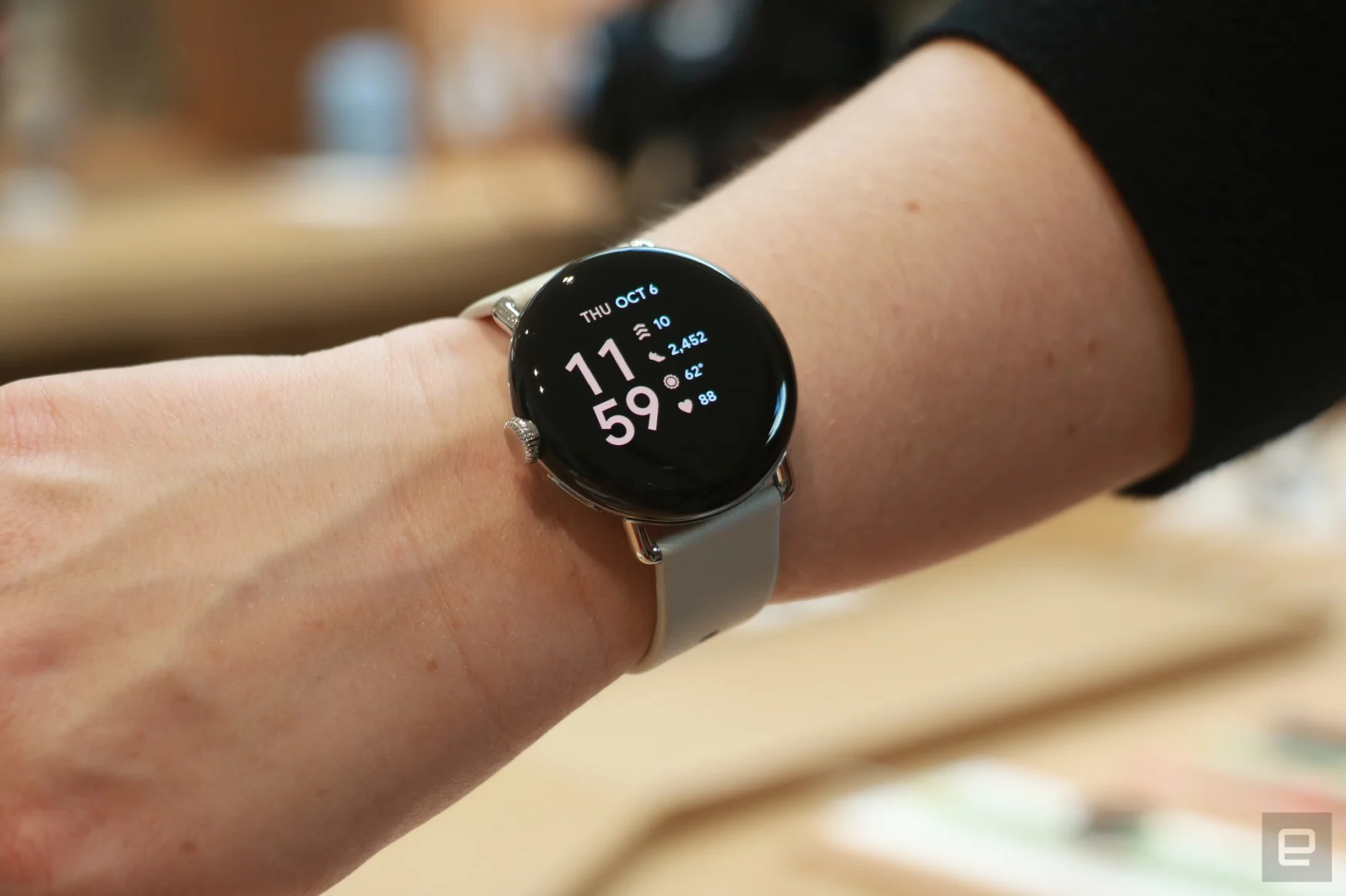 The Google Pixel Watch on a person's wrist.