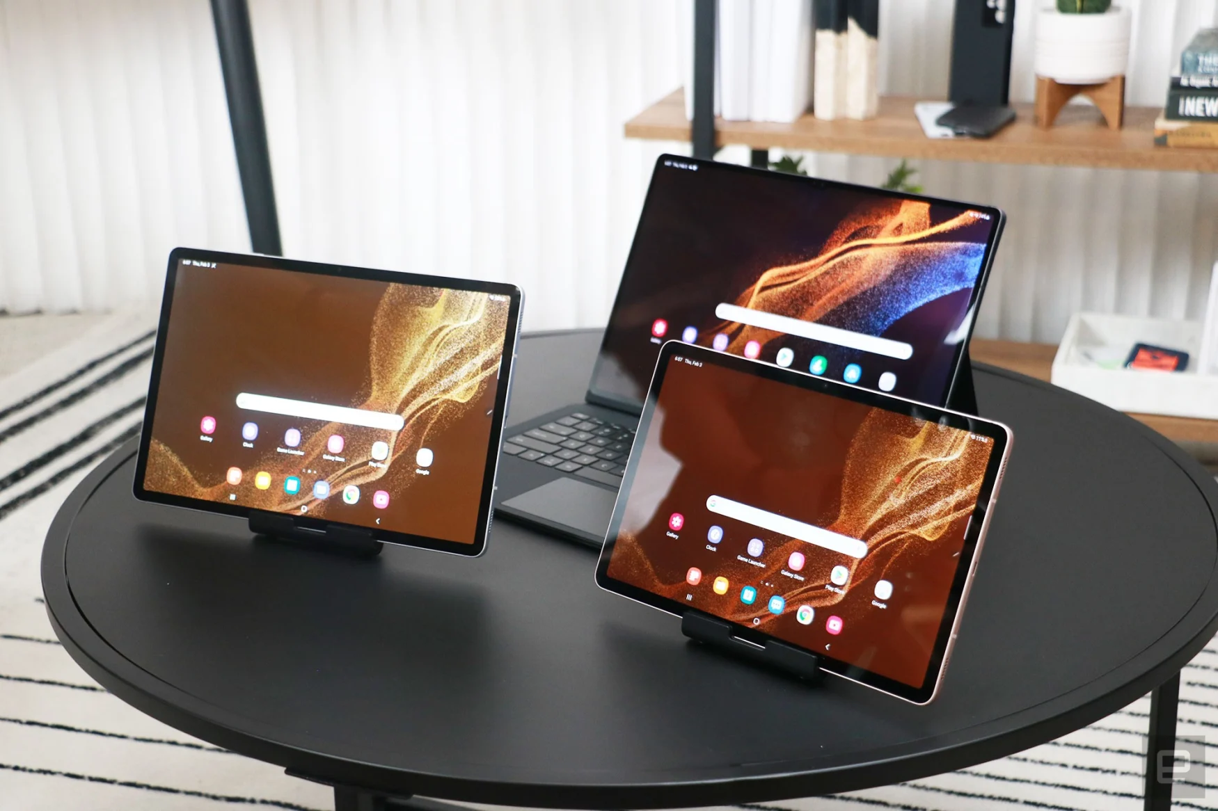 The Galaxy Tab S8, S8+ and S8 Ultra on a table. The S8 and S8+ are propped up on stands, while the Ultra sits behind them with a keyboard case attached.