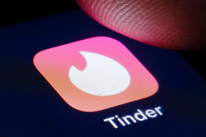 BERLIN, GERMANY - APRIL 22: The logo of mobile dating app Tinder is shown on the display of a smartphone on April 22, 2020 in Berlin, Germany. (Photo by Thomas Trutschel/Photothek via Getty Images)