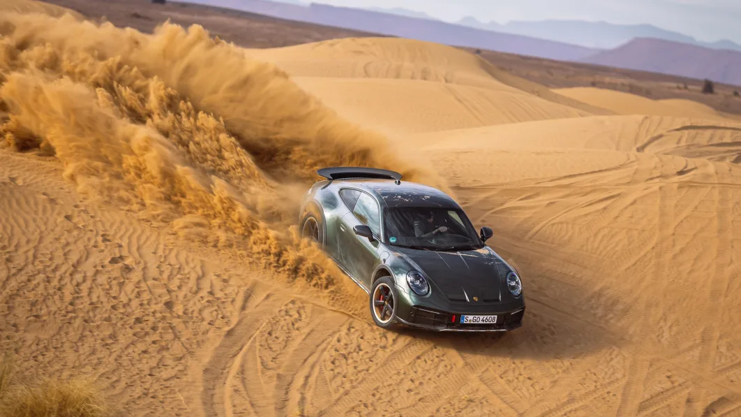 2023 Porsche 911 Dakar in Oak Green downhill on dune from above