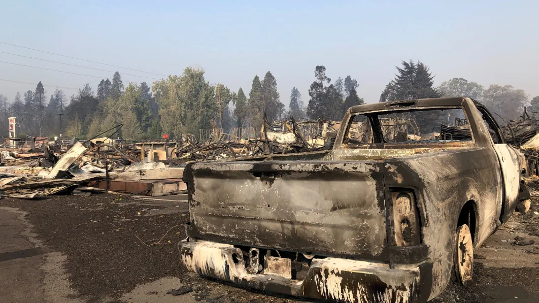 A charred pickup truck sits among the ruins of the Coleman Creek Estates mobile home park in Phoenix, Ore., Thursday, Sept. 10, 2020. The area was destroyed when a wildfire swept through on Tuesday, Sept. 8.. (AP Photo/Gillian Flaccus)
