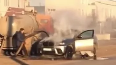 Russian's flaming BMW doused by poo truck