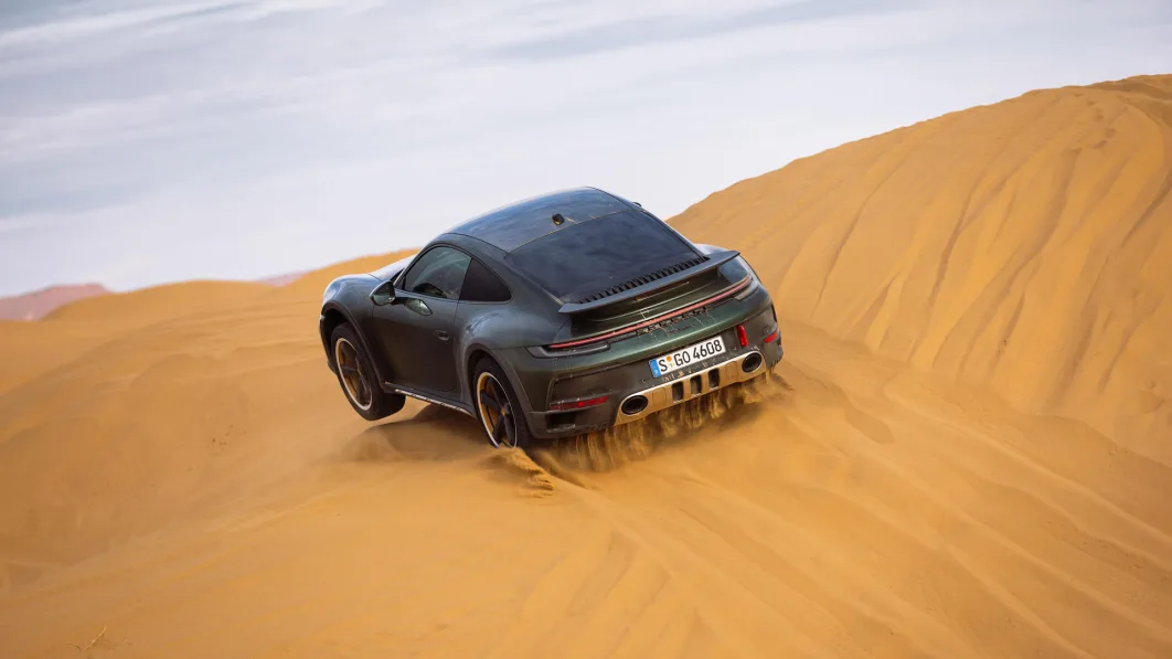 2023 Porsche 911 Dakar in Oak Green rear action on dune